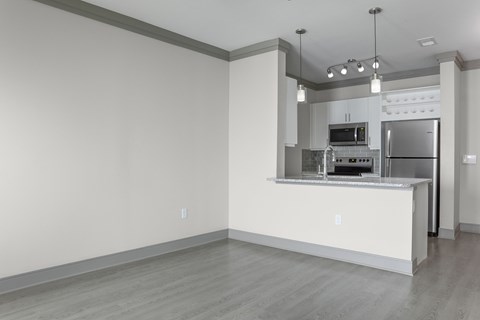 A kitchen with a white counter and stainless steel appliances.