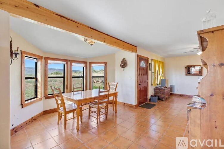 A dining room with a table and chairs is available for rent.