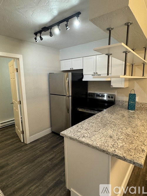 A room with a white closet and carpeted floor.