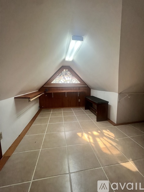 A room with a skylight and tiled flooring.
