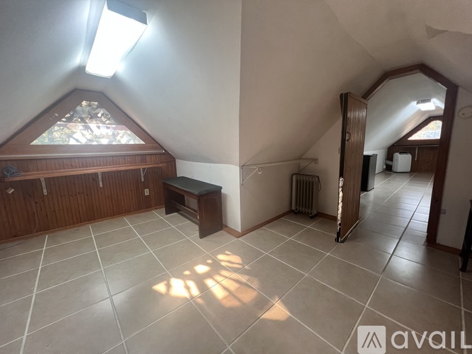 A room with a skylight and a tiled floor.