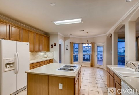 A kitchen with wooden cabinets and a white refrigerator.