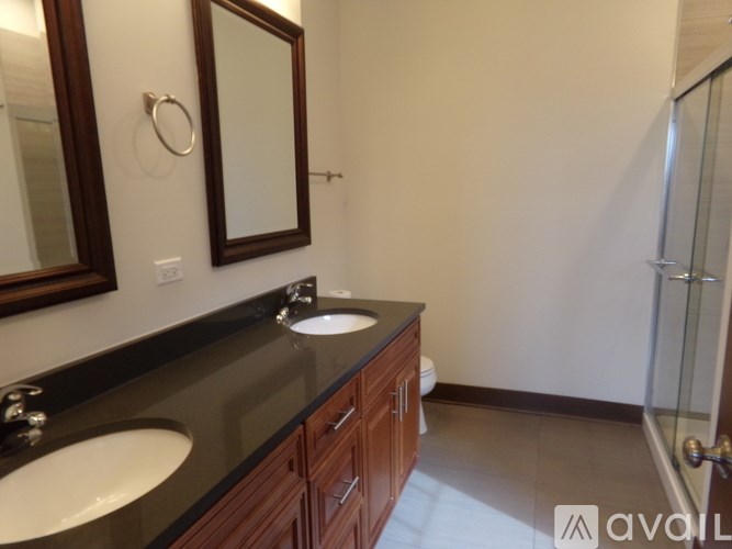A bathroom with a sink, mirror, and toilet.
