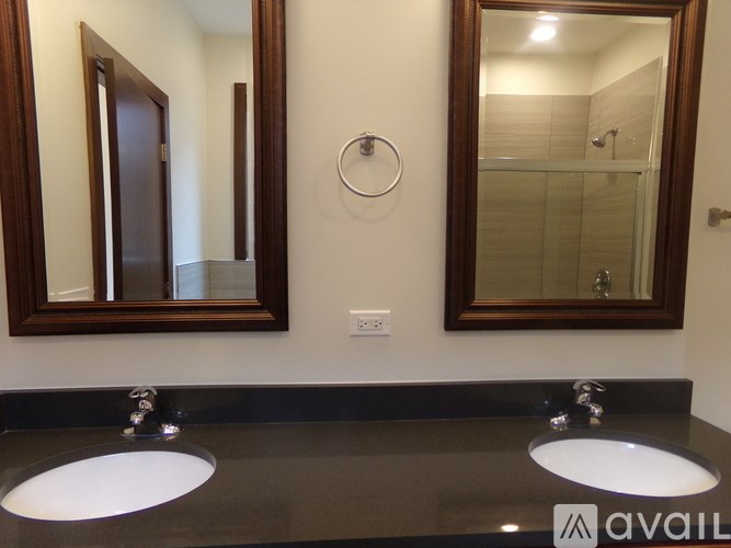 A bathroom with two sinks and mirrors.