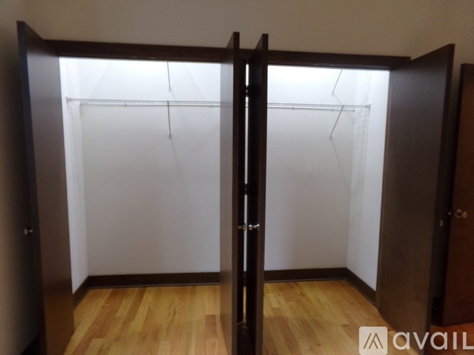 A room with a sliding door and wooden floor.