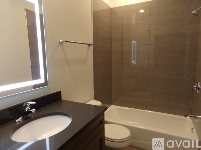 A bathroom with a sink, toilet, and bathtub.