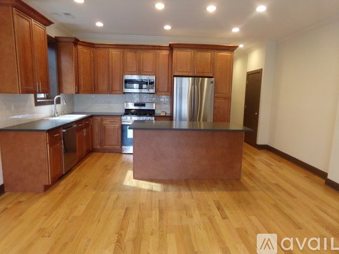 A kitchen with wooden cabinets and a refrigerator.