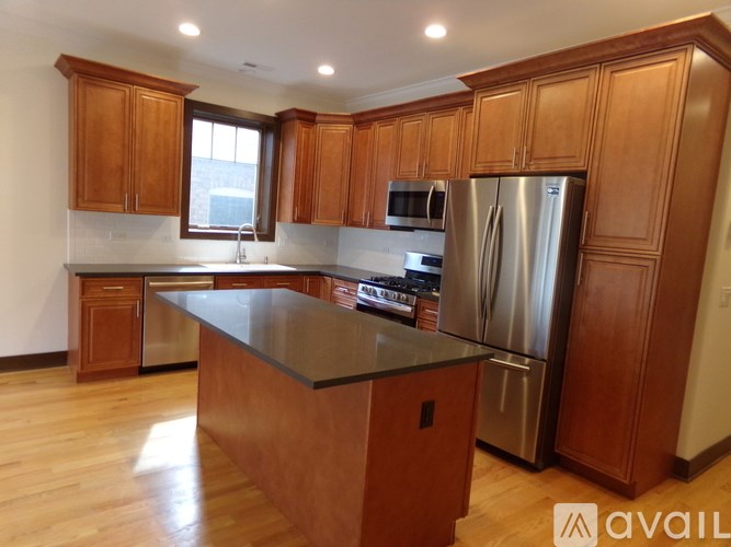 A kitchen with wooden cabinets and a granite countertop.