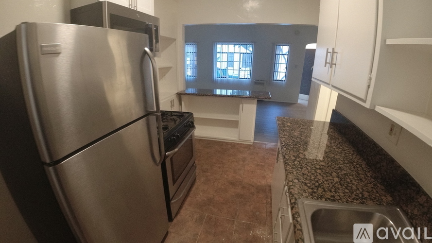A kitchen with a stainless steel refrigerator and a stainless steel dishwasher.