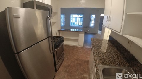 A kitchen with a stainless steel refrigerator and a stainless steel dishwasher.