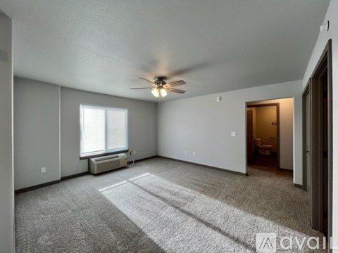 A spacious room with a ceiling fan and a window.