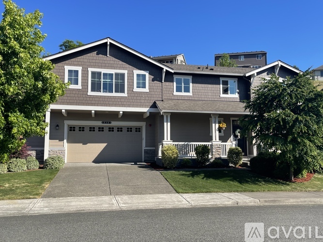 A two-story house with a garage and a front porch.