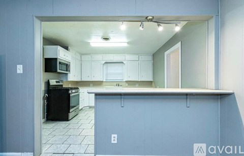 A kitchen with a black oven and microwave.