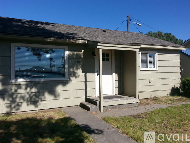 A house with a porch and a door is for sale.