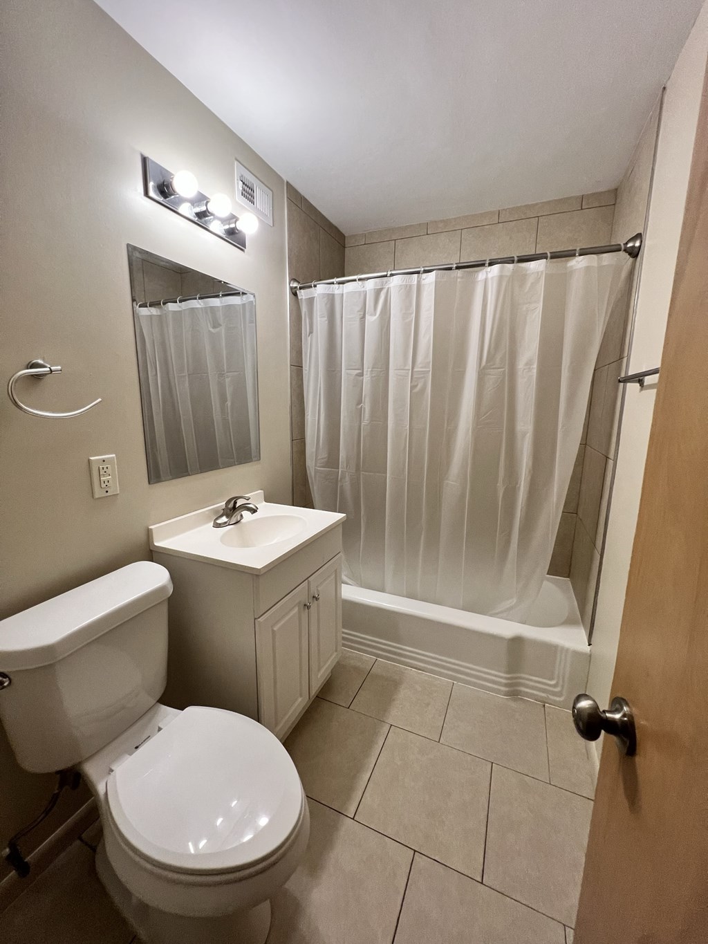 a bathroom with a toilet and a sink and a shower