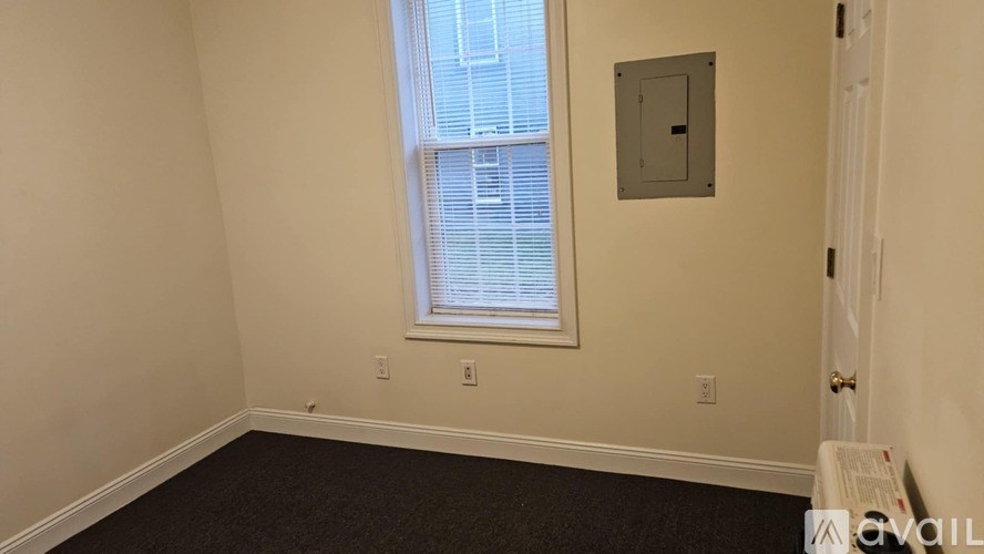A room with a window and a door.