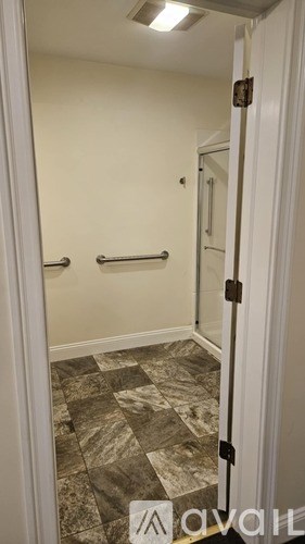 A bathroom with a marble floor and a white door.