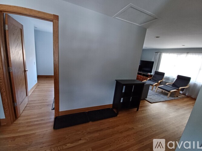 A living room with a black table and chairs.