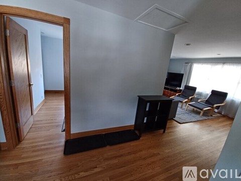 A living room with a black table and chairs.