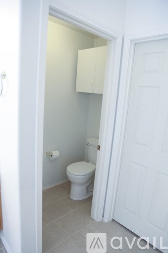 A white toilet in a small bathroom.
