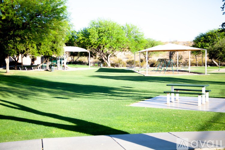 A park with a playground and a picnic table.