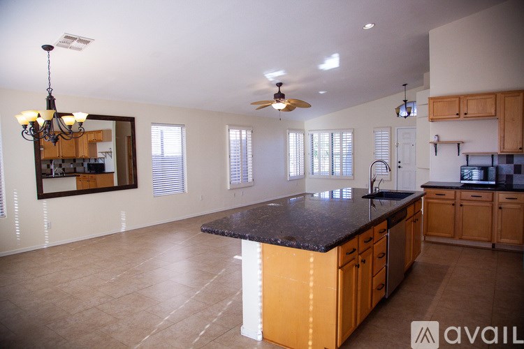 A kitchen with a black countertop and wooden cabinets.
