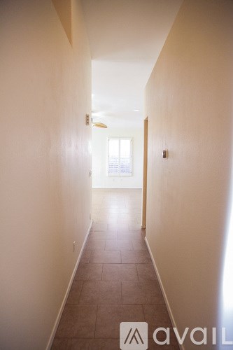 A long hallway with a door at the end.