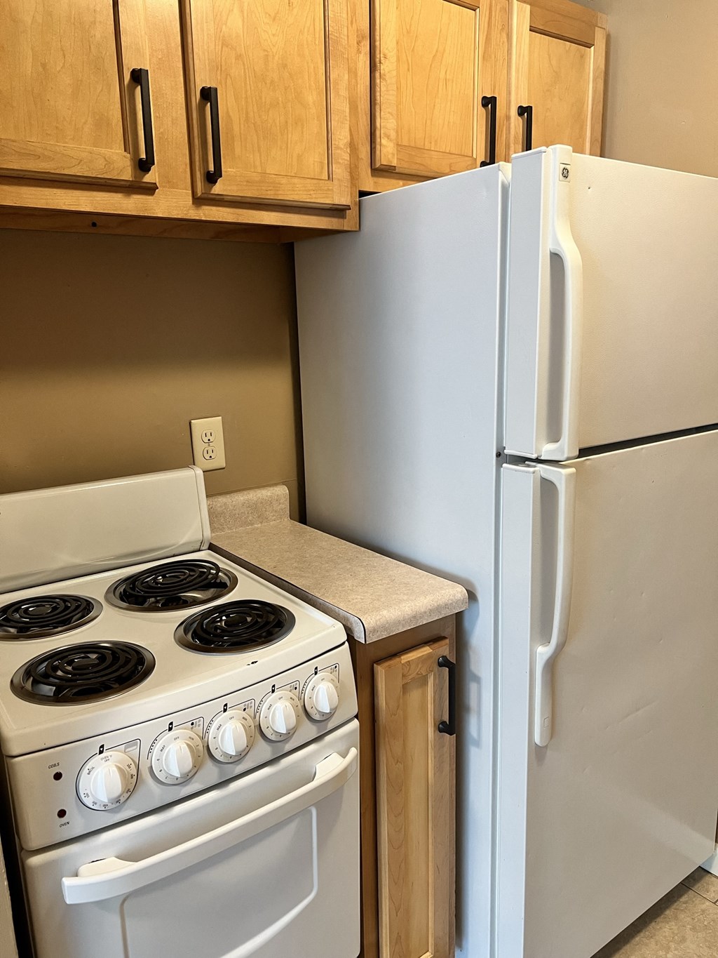 a kitchen with a stove and a refrigerator