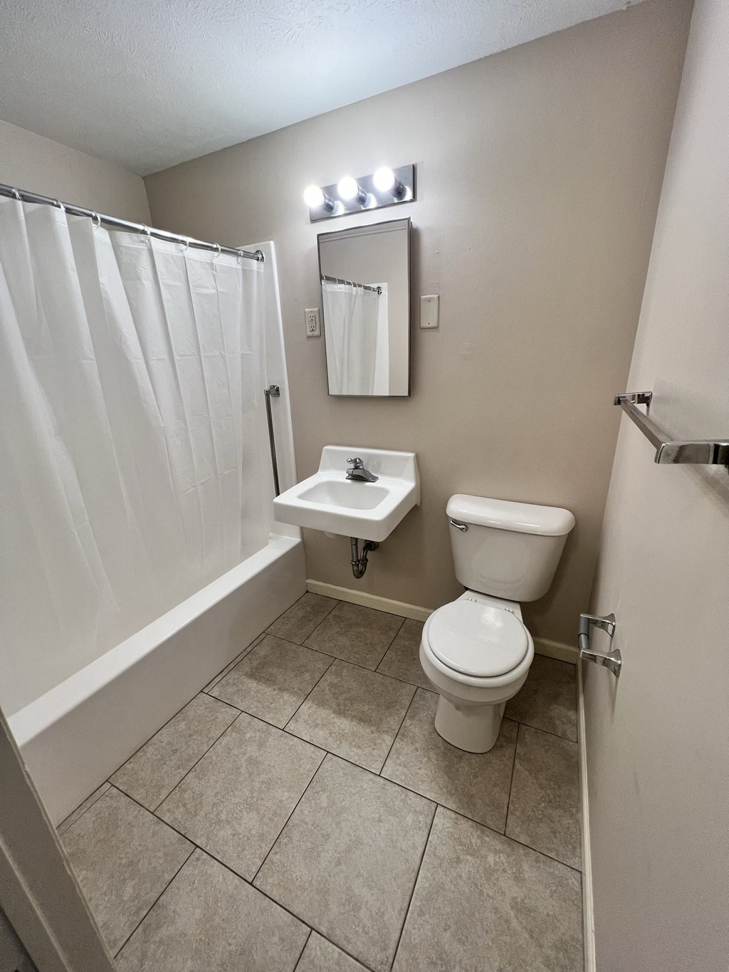 a bathroom with a toilet and a sink and a shower