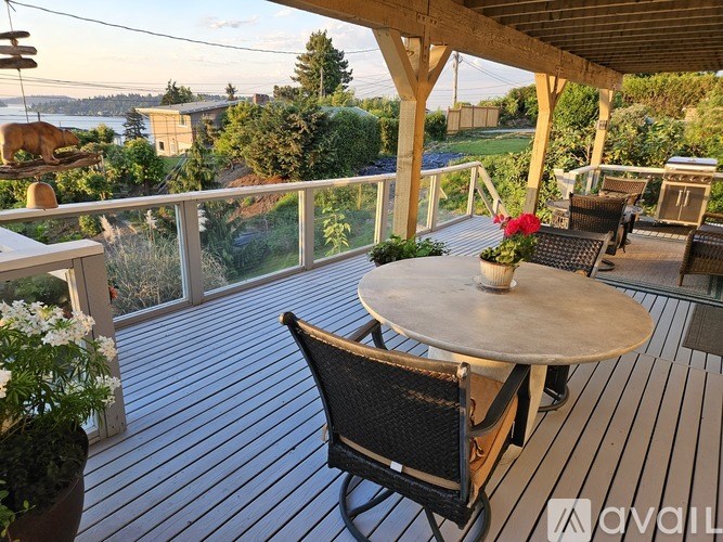 A patio with a table and chairs overlooking a view.