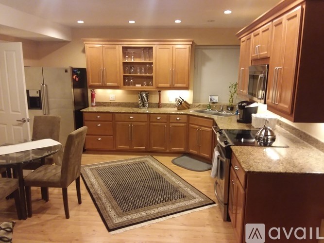 A kitchen with wooden cabinets and a granite countertop.