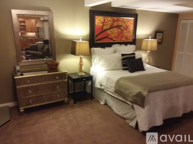 A bedroom with a bed, nightstand, and lamp.