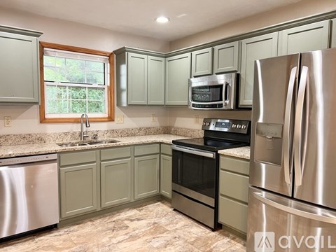 A kitchen with a stainless steel refrigerator and oven.