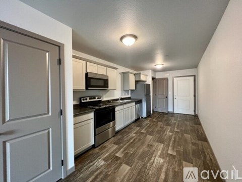 A kitchen with a microwave, oven, and sink.