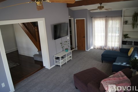 A living room with a blue couch and a white coffee table.