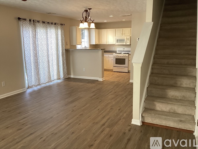 A living room with a staircase leading to the upper floor.