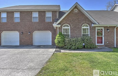 A brick house with a red door and a garage.