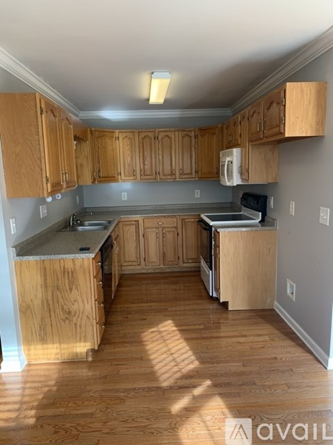 A kitchen with wooden cabinets and a countertop.