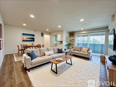 A living room with a white couch and a coffee table.