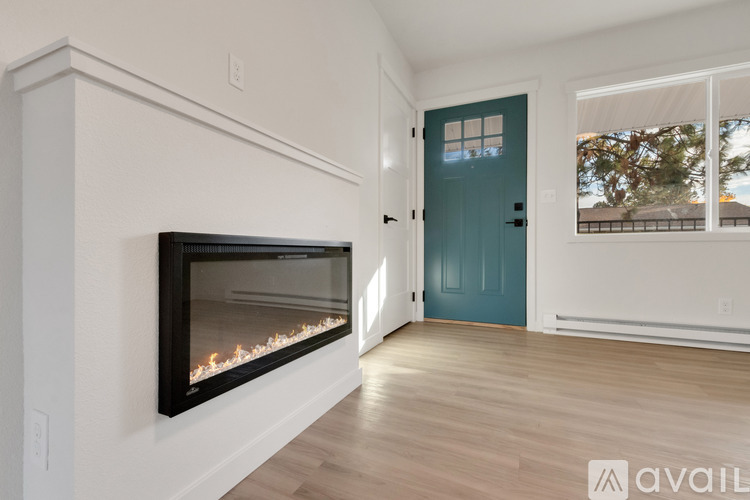 A modern room with a fireplace and a blue door.