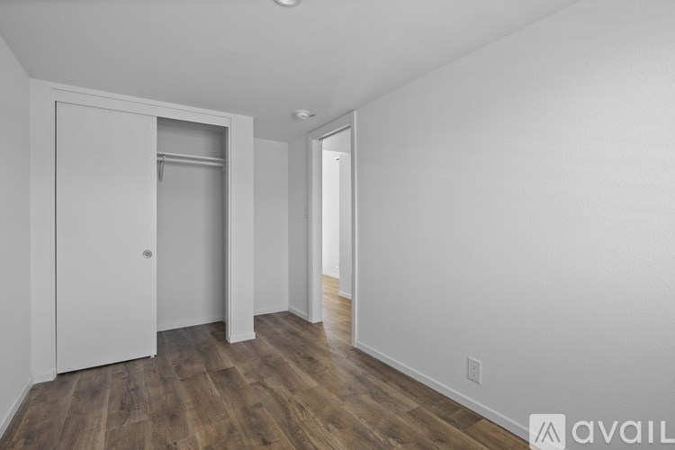 A room with a white door and a window.