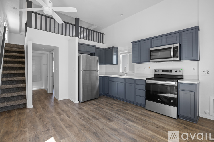 A modern kitchen with a stainless steel refrigerator and dark wood cabinets.