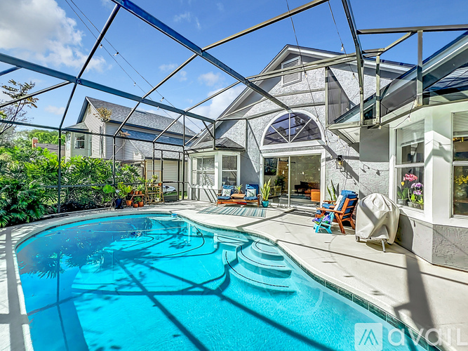 A swimming pool in a house with a glass roof.