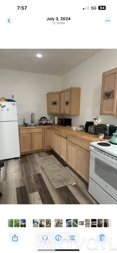 A kitchen with wooden cabinets and a white refrigerator.