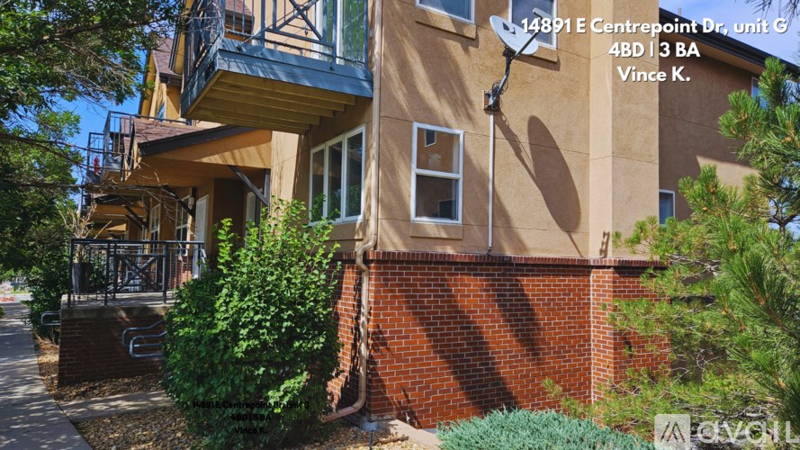A building with a balcony and a sign that reads 14891 E Centrepoint Dr, unit G, 4BD 3 BA, Vince K.