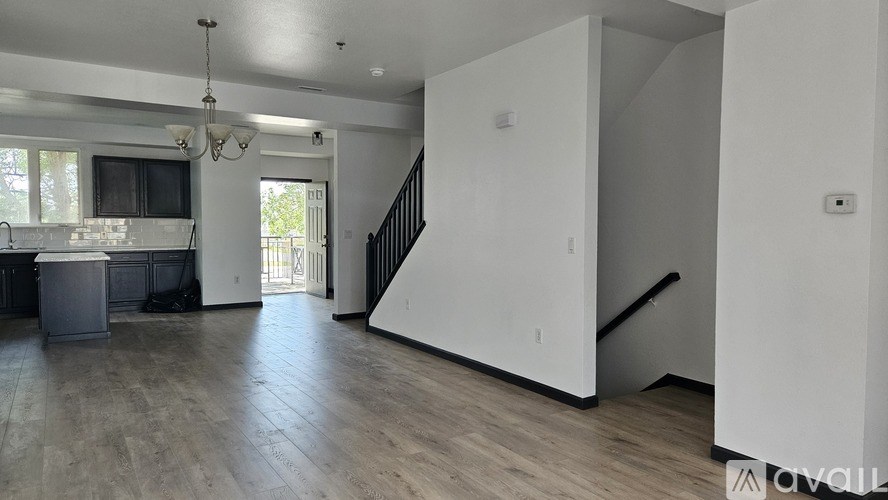 A spacious living room with a staircase leading to the upper floor.
