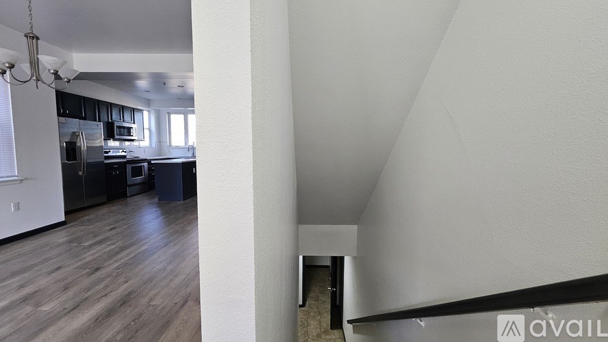 A kitchen with a refrigerator, oven, and cabinets.