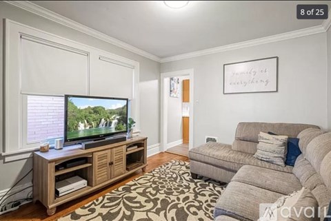 A living room with a television and a couch.