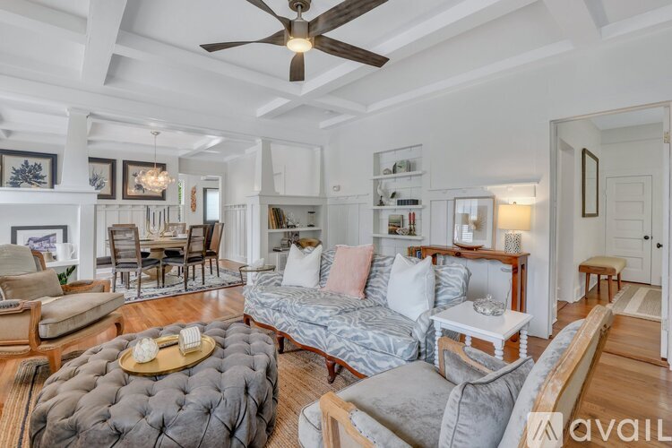 A living room with a grey sofa and a wooden coffee table.