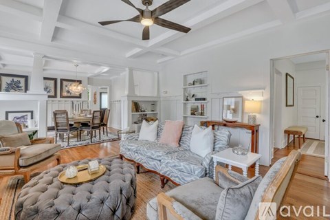 A living room with a grey sofa and a wooden coffee table.